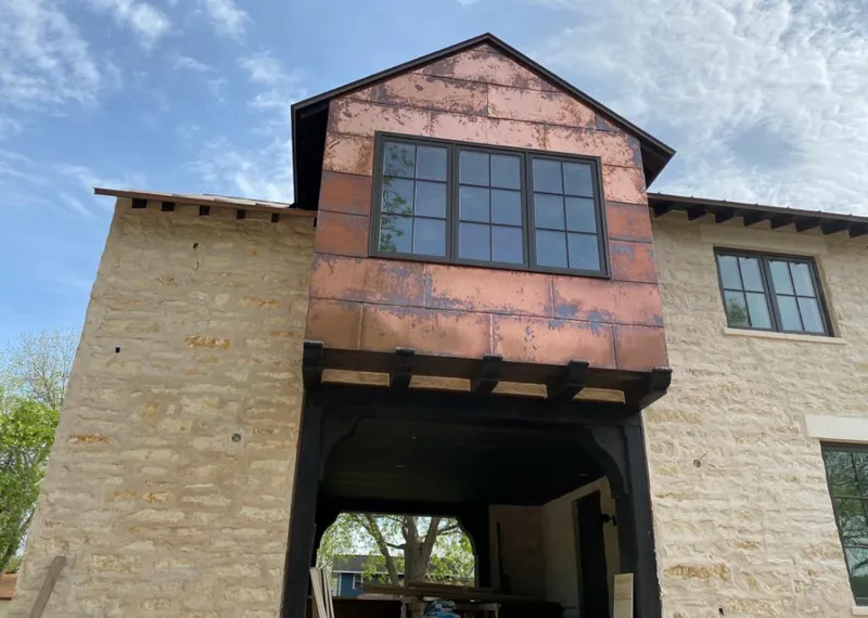Copper metal panel facade on a stone building for Metal Roof Coating in Castaic